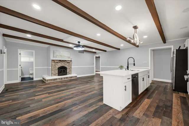 a view of kitchen with sink microwave and refrigerator