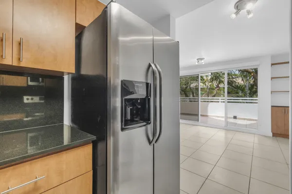 a view of a refrigerator and window in a kitchen