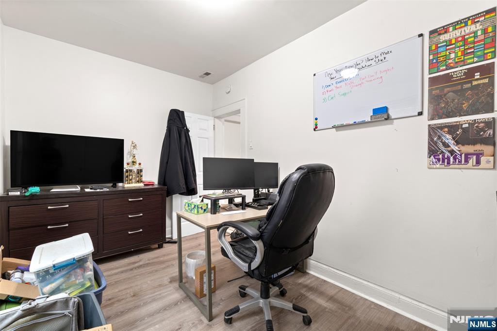 92 South Devine Street Newark, NJ 07106 - Photo 11 of 33 a view of a workspace with furniture and a flat screen tv