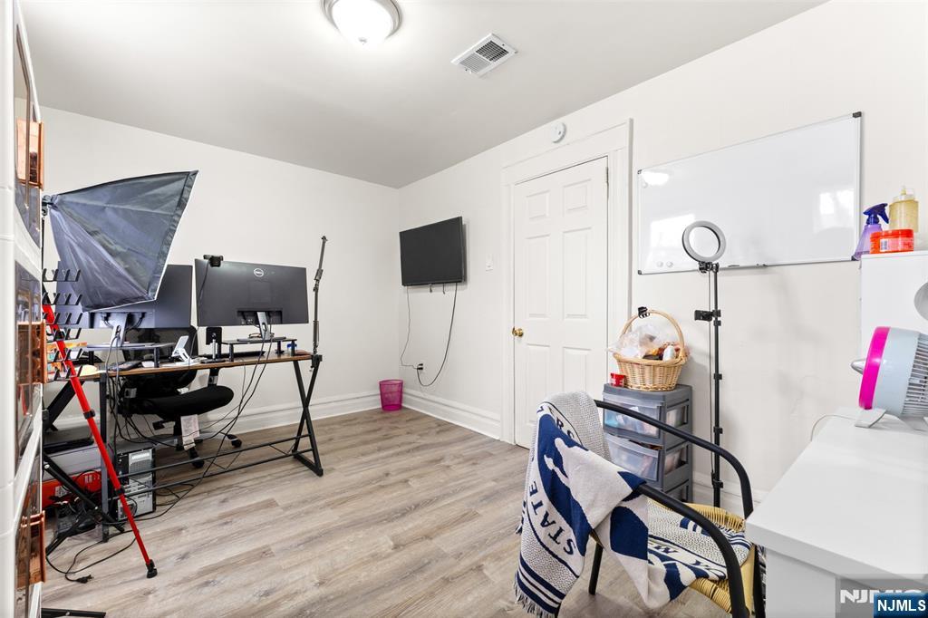 92 South Devine Street Newark, NJ 07106 - Photo 15 of 33 a view of a workspace with furniture and a gym machine