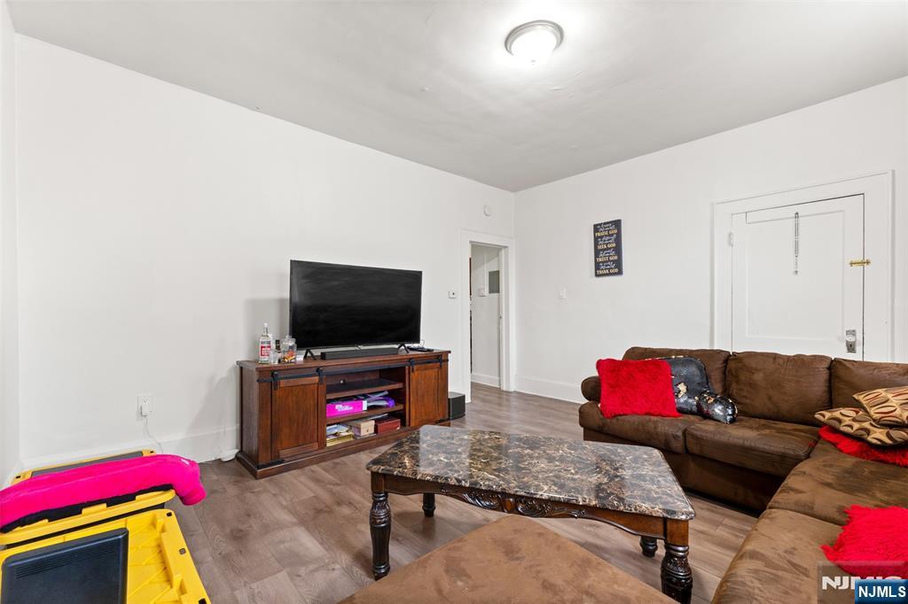 92 South Devine Street Newark, NJ 07106 - Photo 17 of 33 a living room with furniture and a flat screen tv