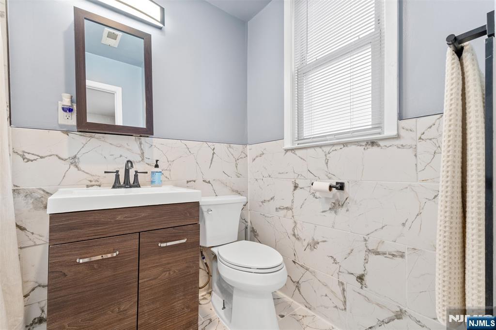 92 South Devine Street Newark, NJ 07106 - Photo 8 of 33 a bathroom with a sink vanity mirror and toilet