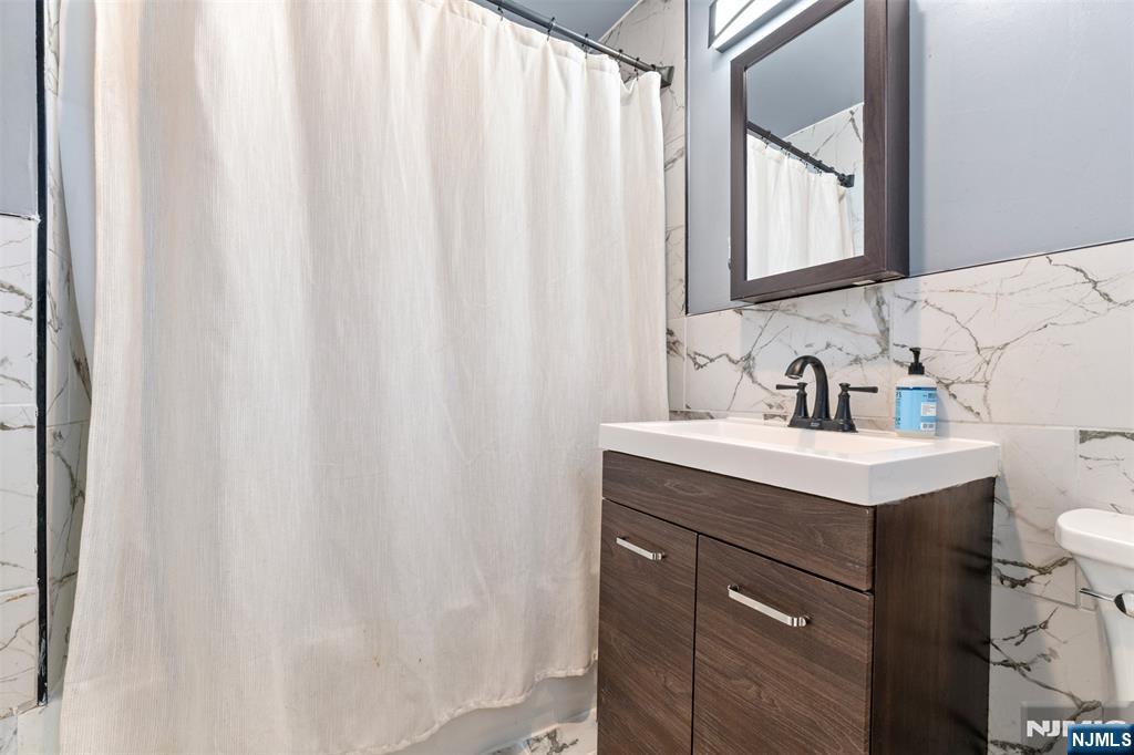 92 South Devine Street Newark, NJ 07106 - Photo 9 of 33 a bathroom with a sink and a mirror