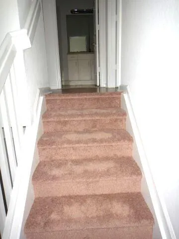 a view of a hallway with stairs