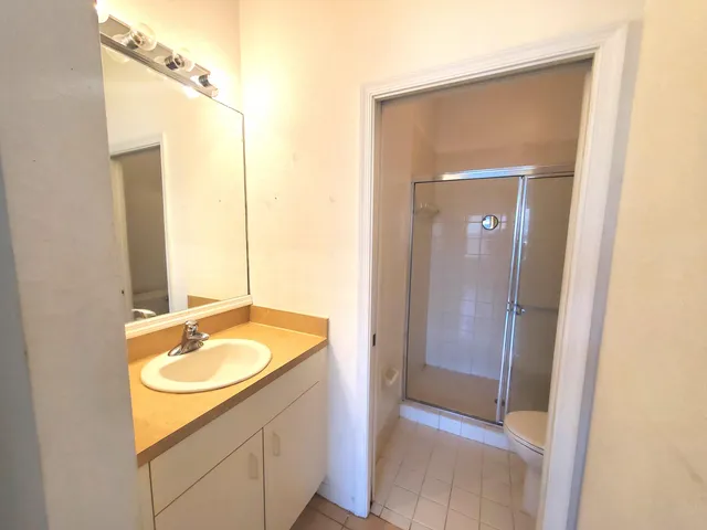 a bathroom with a sink a mirror and a shower