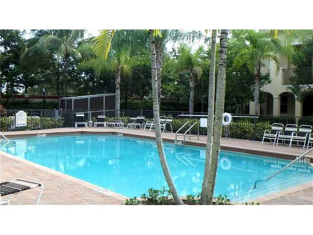 a swimming pool view with a garden space