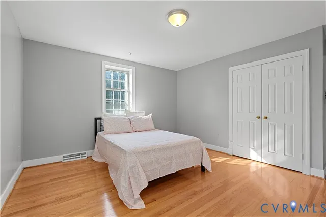 a bathroom with a granite countertop sink toilet and mirror