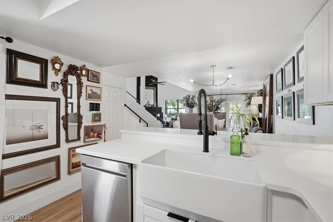 6250 West Flamingo Road, Unit 93 Las Vegas, NV 89103 - Photo 14 of 38 This bright kitchen features a large farmhouse sink, offering both style and functionality for daily living.