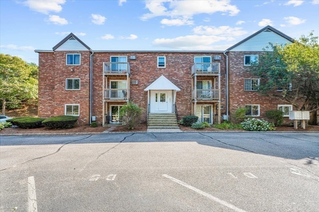 90-92 Sandwich Road, Unit 2D Bourne, MA 02532 - Photo 14 of 29 front view of a brick house with a yard