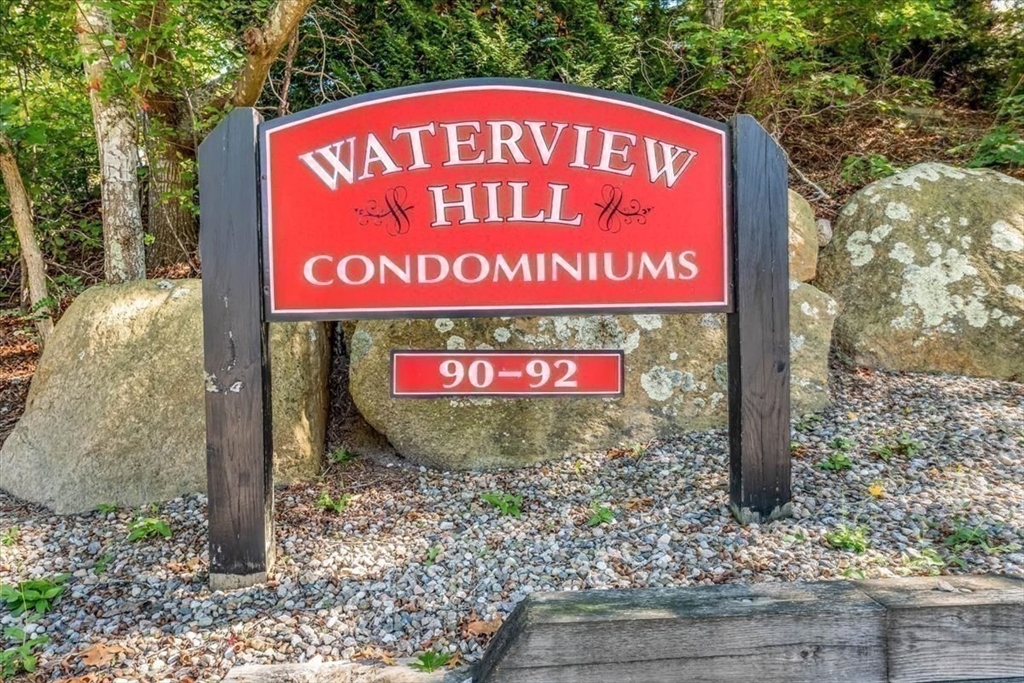 90-92 Sandwich Road, Unit 2D Bourne, MA 02532 - Photo 15 of 29 a sign on the side of the road