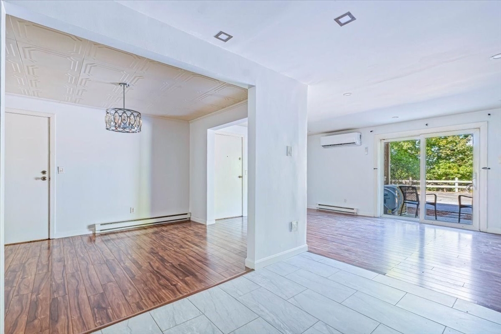 90-92 Sandwich Road, Unit 2D Bourne, MA 02532 - Photo 21 of 29 wooden floor in an empty room with a window