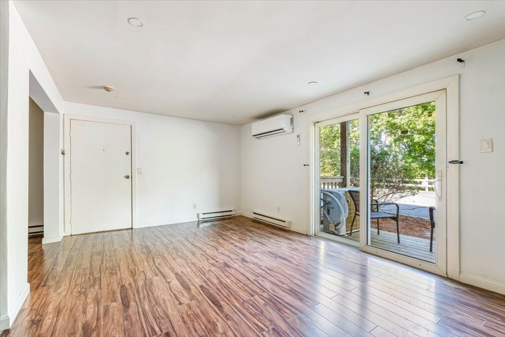 90-92 Sandwich Road, Unit 2D Bourne, MA 02532 - Photo 24 of 29 a view of empty room with wooden floor and fan