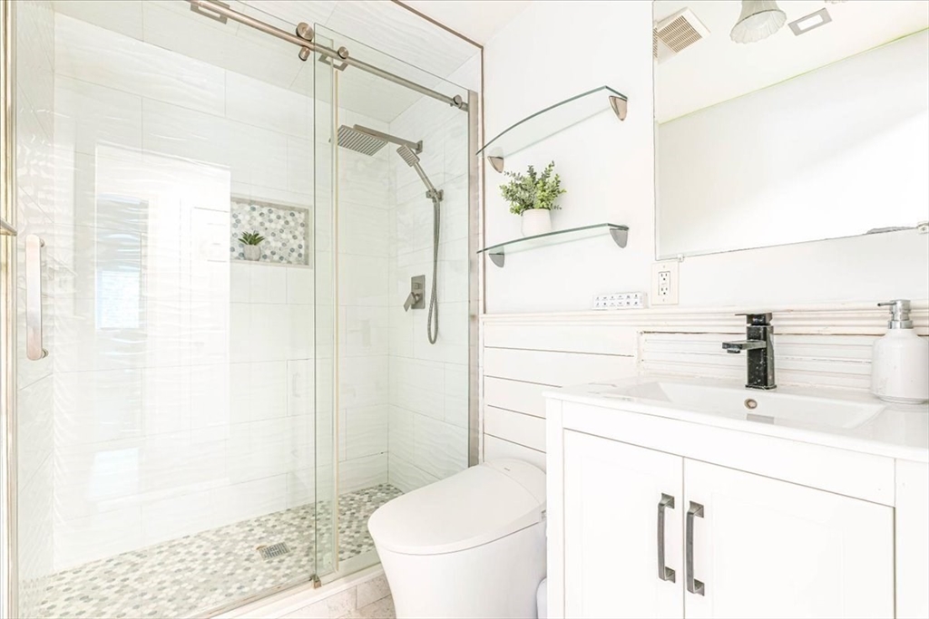 90-92 Sandwich Road, Unit 2D Bourne, MA 02532 - Photo 26 of 29 a bathroom with a sink a toilet and shower