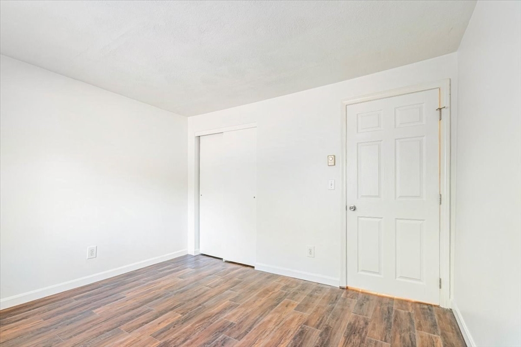 90-92 Sandwich Road, Unit 2D Bourne, MA 02532 - Photo 27 of 29 a view of an empty room with wooden floor