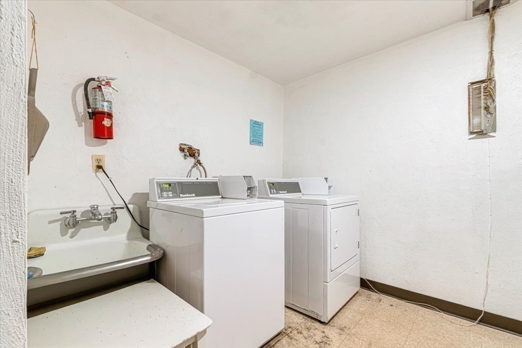 90-92 Sandwich Road, Unit 2D Bourne, MA 02532 - Photo 28 of 29 a room with a sink and wooden floor