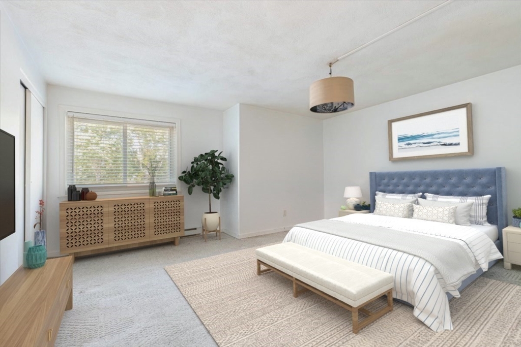 90-92 Sandwich Road, Unit 2D Bourne, MA 02532 - Photo 3 of 29 a bedroom with a large bed and a window