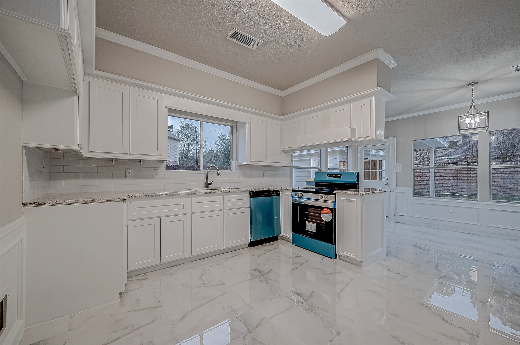 4218 Bayglen Court Houston, TX 77068 - Photo 11 of 42 a kitchen with kitchen island granite countertop a sink cabinets and stainless steel appliances