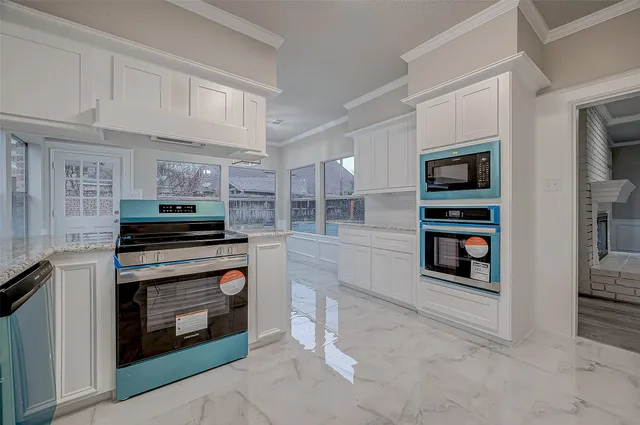 a kitchen with stainless steel appliances a stove and cabinets