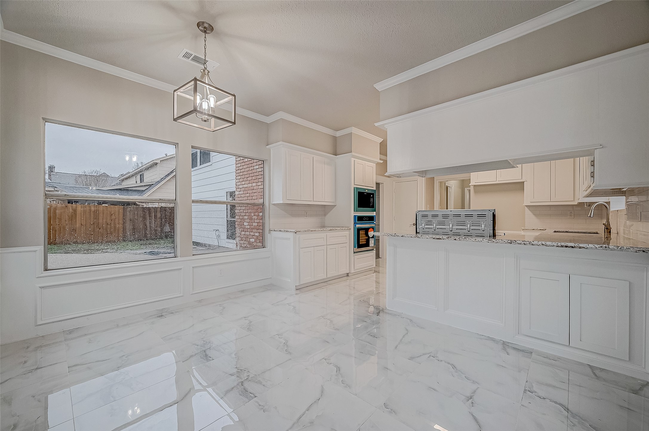 4218 Bayglen Court Houston, TX 77068 - Photo 16 of 42 a large white kitchen with cabinets and a refrigerator