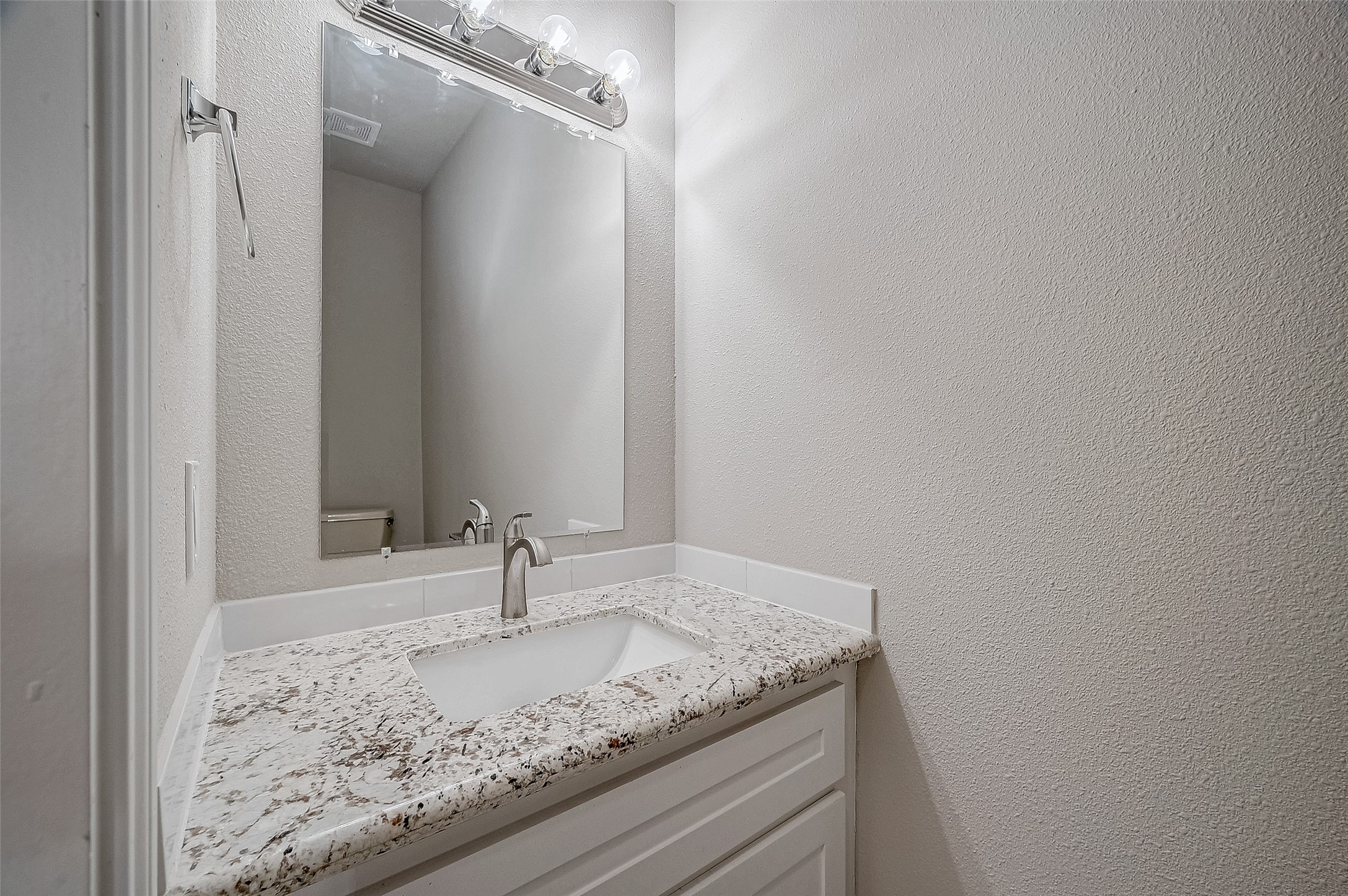 4218 Bayglen Court Houston, TX 77068 - Photo 19 of 42 a bathroom with a granite countertop sink and vanity