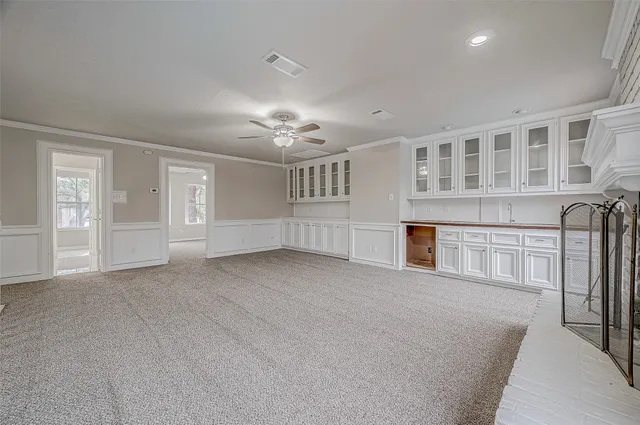 a view of an empty room with chandelier