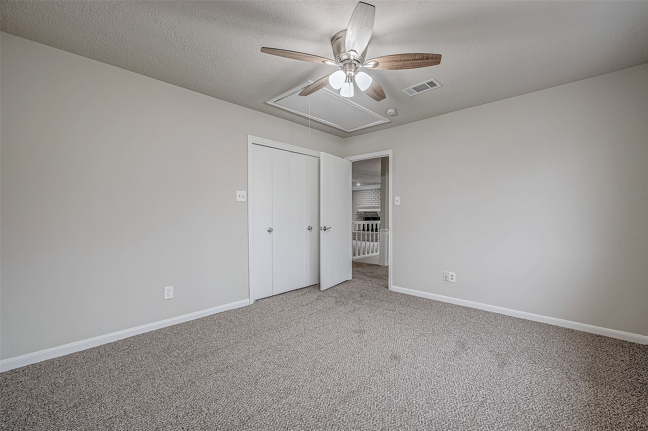 4218 Bayglen Court Houston, TX 77068 - Photo 24 of 42 an empty room with a chandelier fan and a ceiling fan