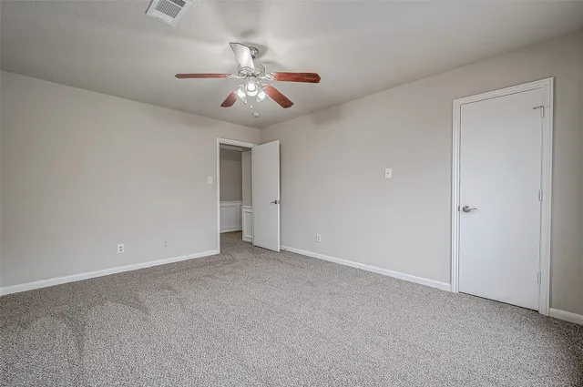 a view of an empty room with a fan