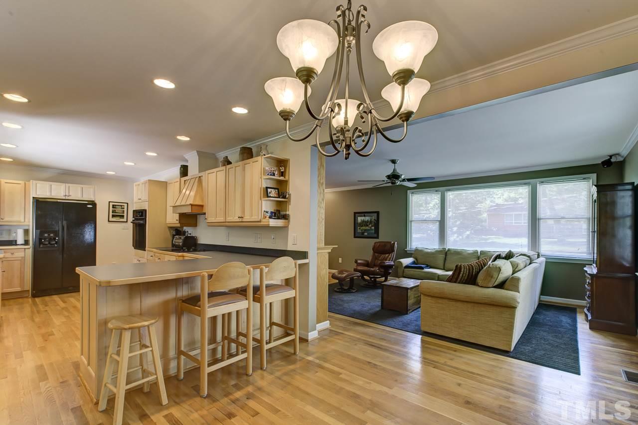 3432 Leonard Street Raleigh, NC 27607 - Photo 5 of 25 a view of a dining room with furniture wooden floor and chandelier
