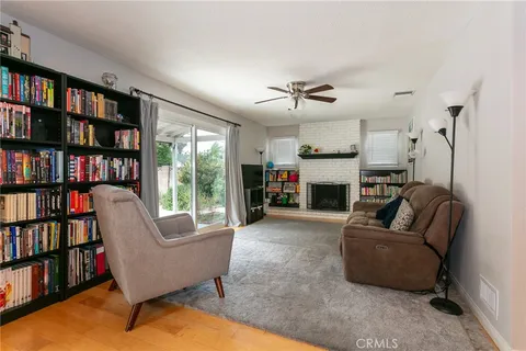 a living room with furniture and a book shelf