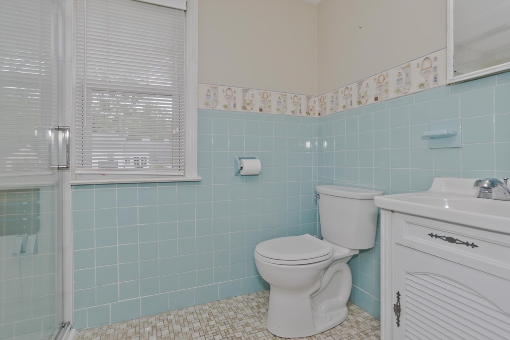 54 Mohawk Drive Springfield, MA 01129 - Photo 15 of 35 a bathroom with a toilet a sink and mirror