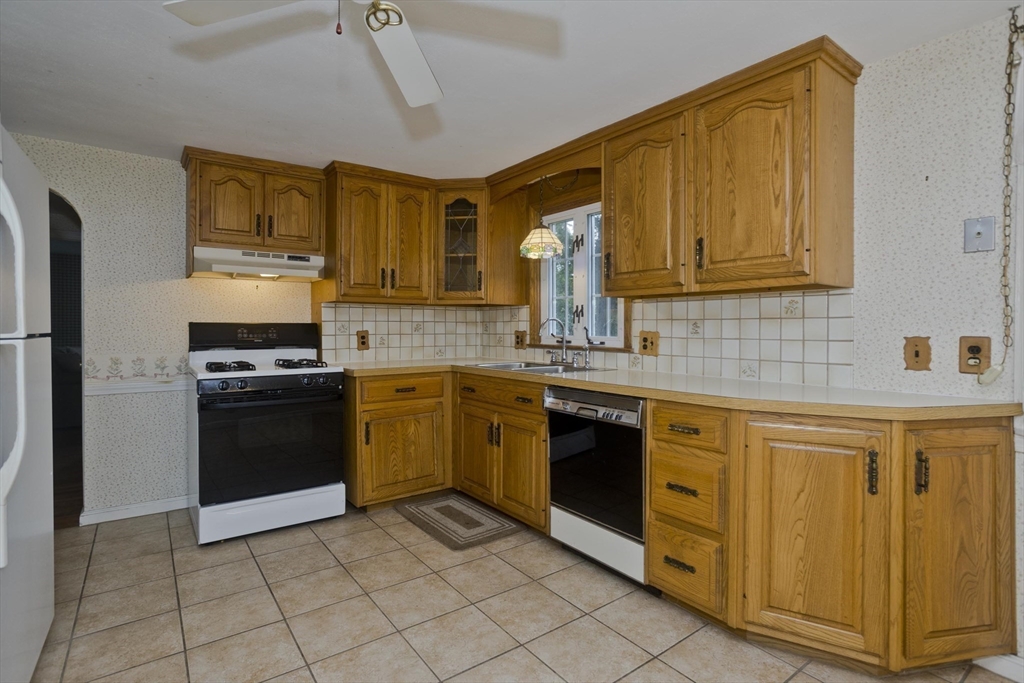 54 Mohawk Drive Springfield, MA 01129 - Photo 5 of 35 a kitchen with stainless steel appliances granite countertop a stove sink and cabinets
