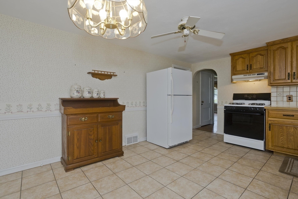54 Mohawk Drive Springfield, MA 01129 - Photo 7 of 35 a kitchen with stainless steel appliances a refrigerator and a stove top oven