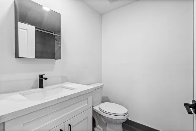 a bathroom with a shower a toilet and a sink