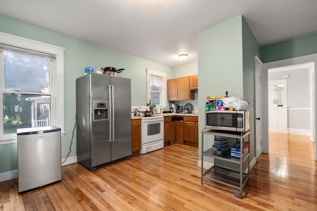 5 Bay State Road Worcester, MA 01606 - Photo 2 of 21 a kitchen with stainless steel appliances a refrigerator and wooden floor