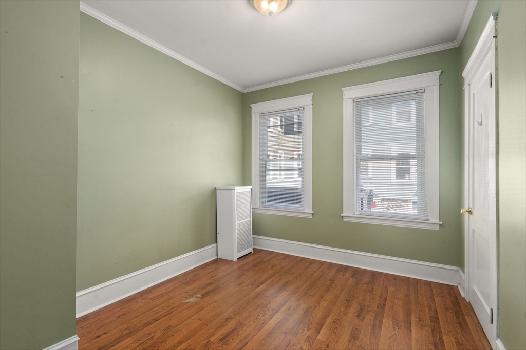 5 Bay State Road Worcester, MA 01606 - Photo 9 of 21 an empty room with wooden floor and windows