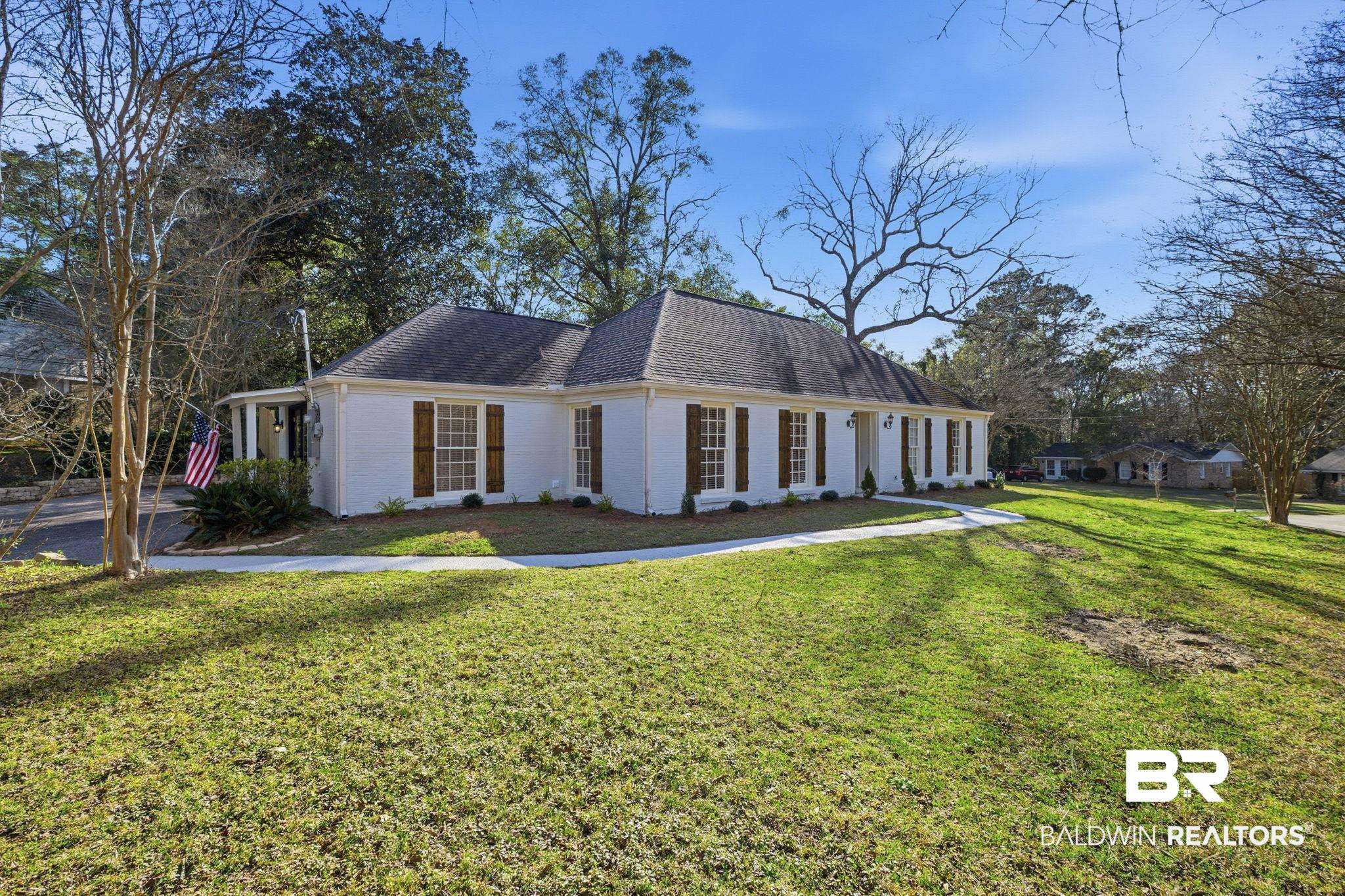 814 Nassau Drive Mobile, AL 36608 - Photo 32 of 44 View of front facade with roof with shingles, brick siding, and a front yard