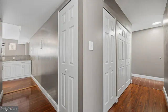 a bathroom with a granite countertop sink a toilet and shower