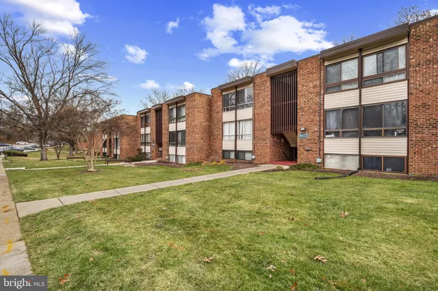 a pathway of a house with a yard