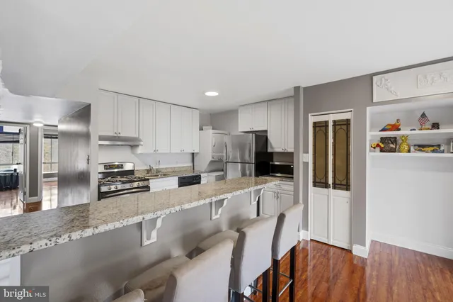 a kitchen with wooden floors and appliances