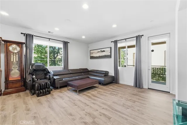 a living room with furniture and large windows