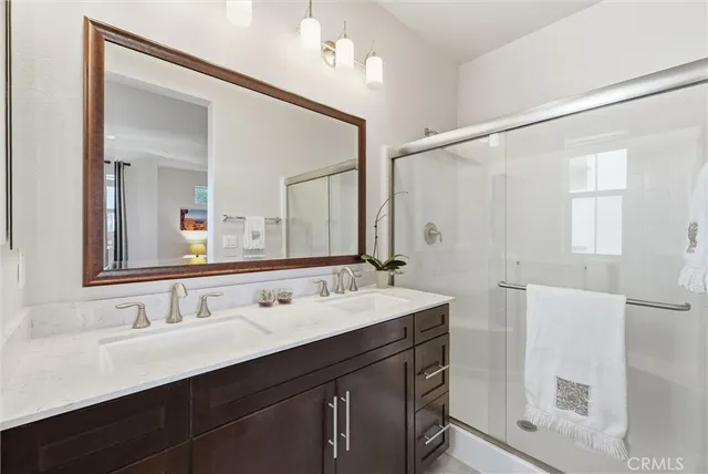 a bathroom with a double vanity sink mirror and double