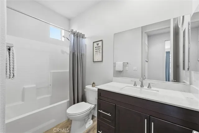 a bathroom with a sink a toilet a shower and a mirror