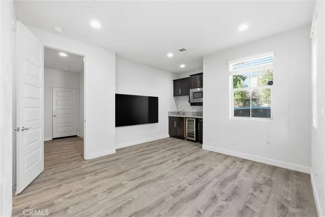 an empty room with wooden floor and fireplace