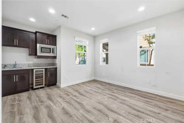 a kitchen with stainless steel appliances granite countertop a refrigerator and a stove top oven