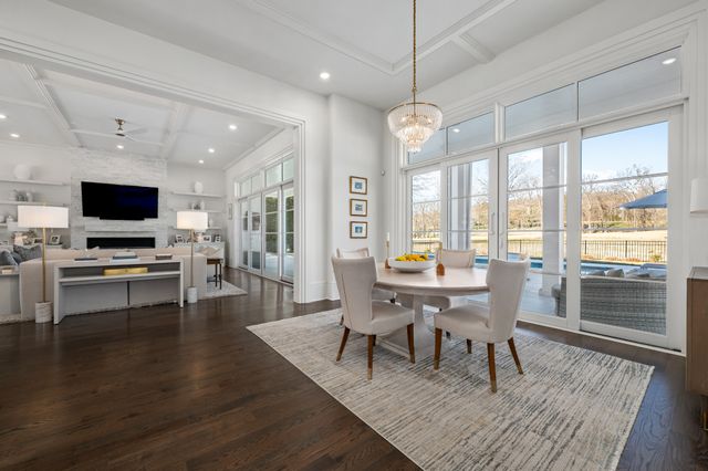 a living room with patio furniture and a floor to ceiling window