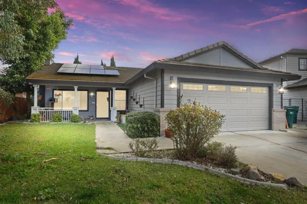 a front view of a house with garden