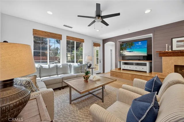 a living room with furniture a large window and a flat screen tv