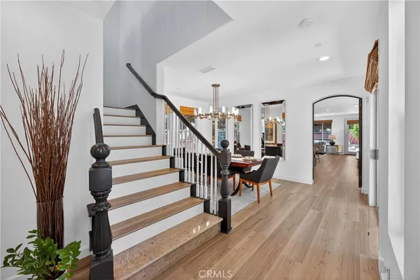 a dining room with furniture a chandelier and window