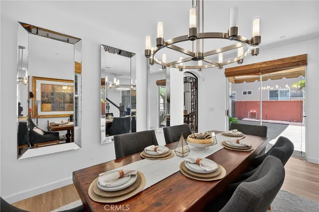 a kitchen with stainless steel appliances granite countertop a kitchen island a stove a table and chairs in it