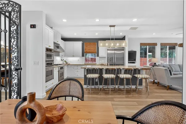 a kitchen with stainless steel appliances granite countertop grey cabinets a stove a sink and a microwave